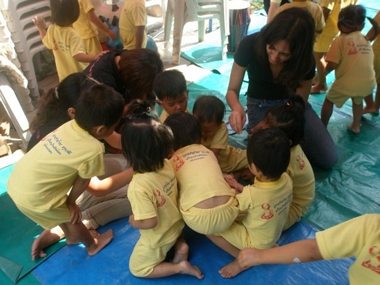 GLSP participants interact with a group of children at the Foundation for Slum Child Care, one of two sites within the slum area at which the students worked. Another group worked with people with disabilities at a government-run center.