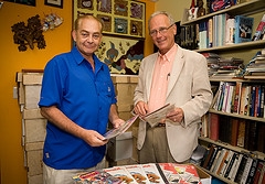 Business school faculty member and comic book collector Paul Miniard presented Robert Hogner more than 7,000 comic books to be used as a fundraiser for the Alternative Break-Global Leadership and Service Project.