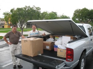 America’s Moms volunteers Tom Kelaher and Dan Smith with one of two truckloads of items for care packages.
