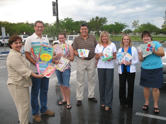 From left to right: Jackie Nasreddine, BBA+ Weekend student; Dan Smith, chair, America's Moms; Kylie Kelaher, Tom Kelaher, director, America's Moms; Judy Smith, director, America's Moms, BBA+ Weekend student Linda Henderson and Cindy Esquivel, AT&T Pioneers display cards created by Art Studio Miami, Cub Scout Pack # 941 and Gladeview Christian School.