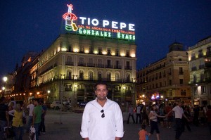 Yousef Al-Saleh in front of the famous Tio Pepe sign in Puerta del Sol, a plaza in the heart of Madrid