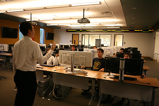 Owen Lee provides instruction about financial markets to students from Christopher Columbus High School.