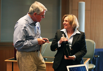 Doug Gallagher presents Joyce J. Elam, executive dean, with a bottle of Sonador from his Napa Valley vineyard.
