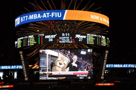 FIU mascot Roary with Mark Rosenberg, FIU president, on the Miami Heat scoreboard