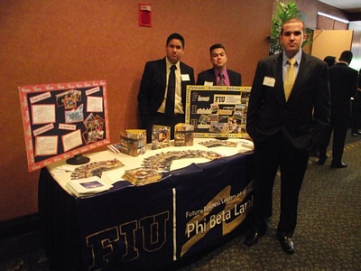 Chapter president Bruno Cevallos and member Mauricio Rodrigues, behind the information table, with recruitment committee chair and historian Jose Nunez
