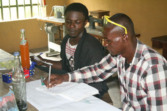 Essien and Effiom, two of the school’s trainers and part of the first graduating class, focus on curriculum development at a recent on-site workshop.