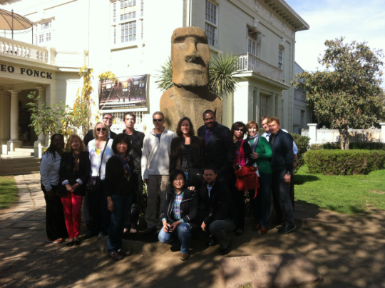 Participants in the 16th Mercosur Professional Development in International Business at the Museo Fonck in Viña Del Mar in front of an Easter Island head