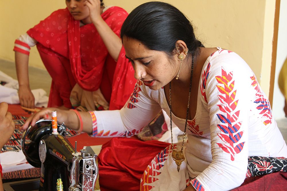 Bandhwari woman at sewing machine