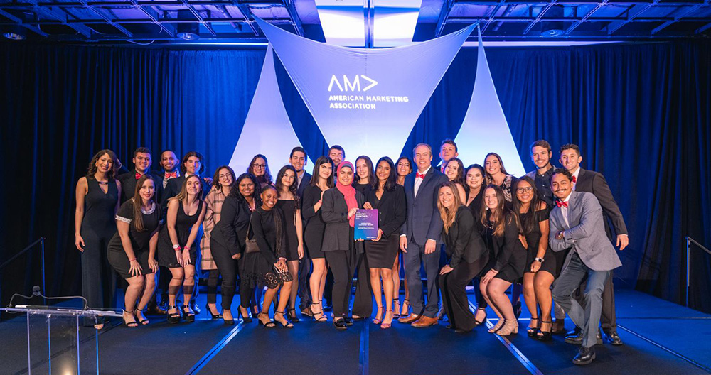 AMA FIU members on stage with their award.